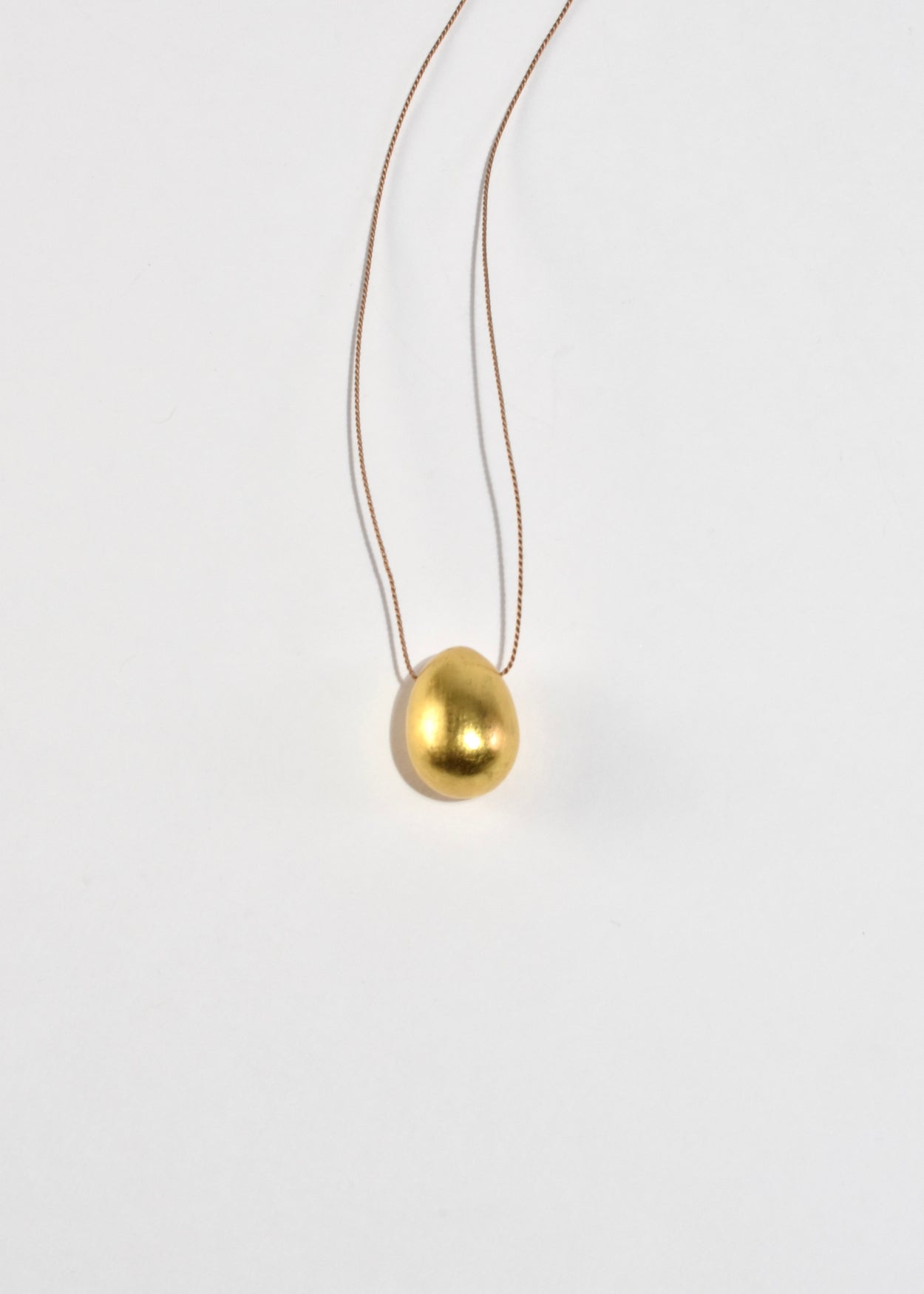 Gold Egg Necklace on Silk Cord