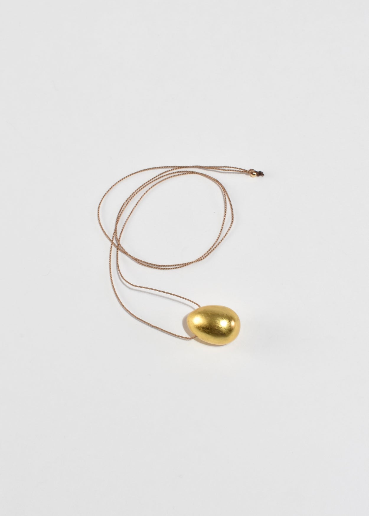 Gold Egg Necklace on Silk Cord